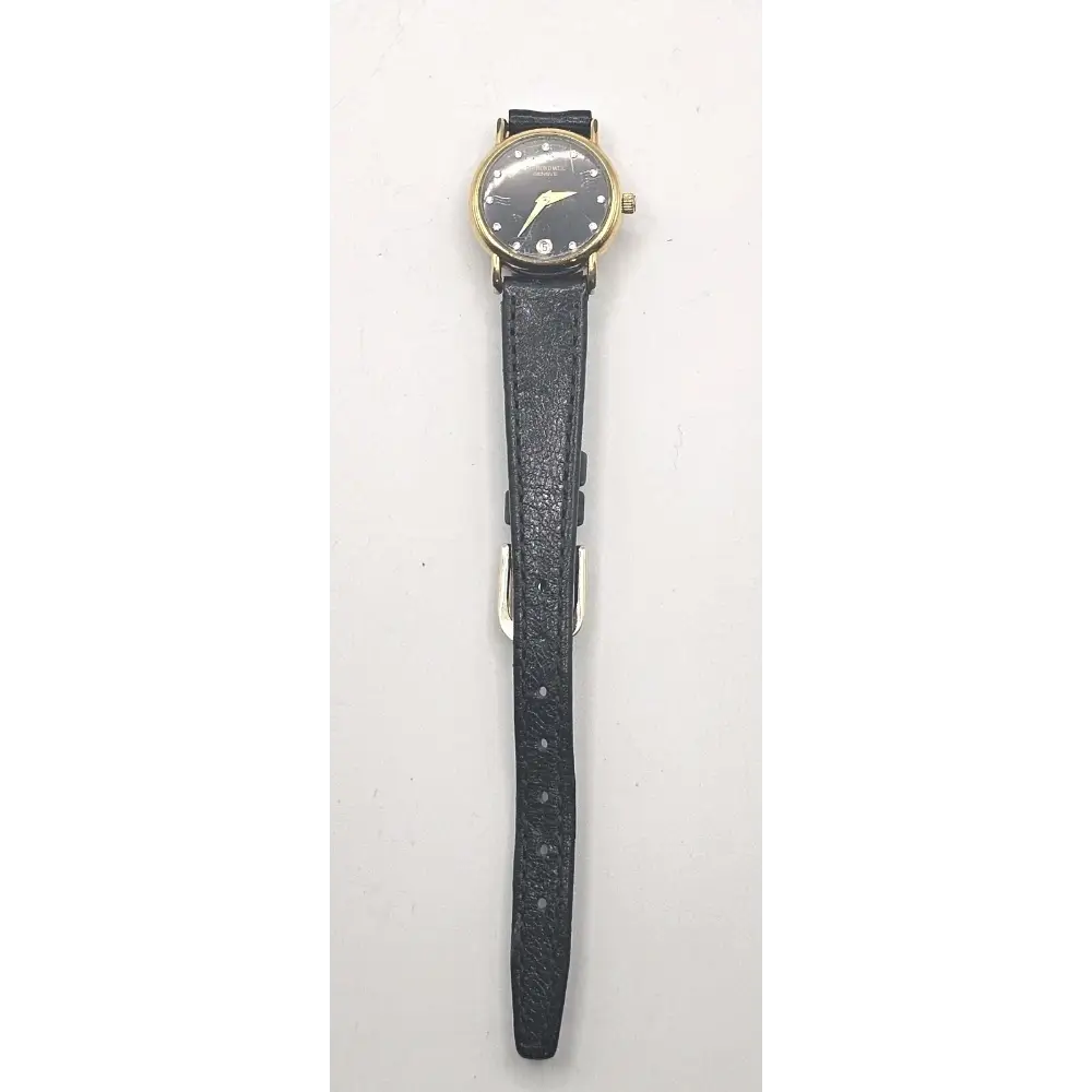 Wristwatch with black strap and gold case on a white background