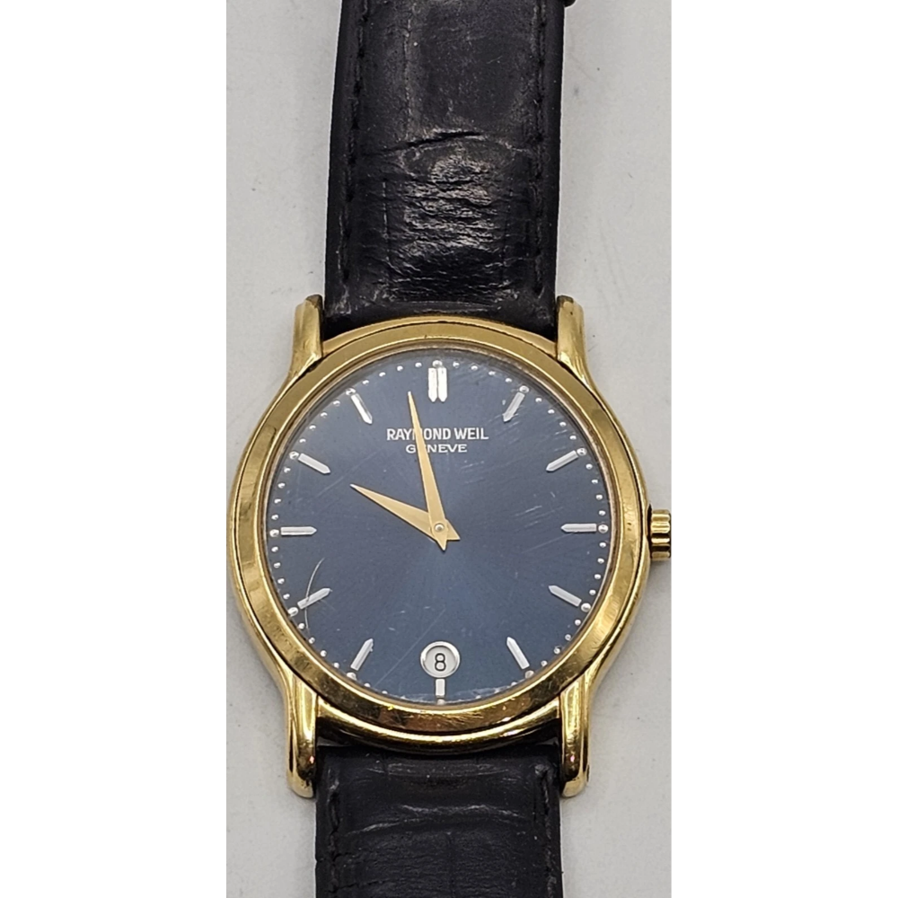 Raymond Weil watch with black face and gold case on a white background