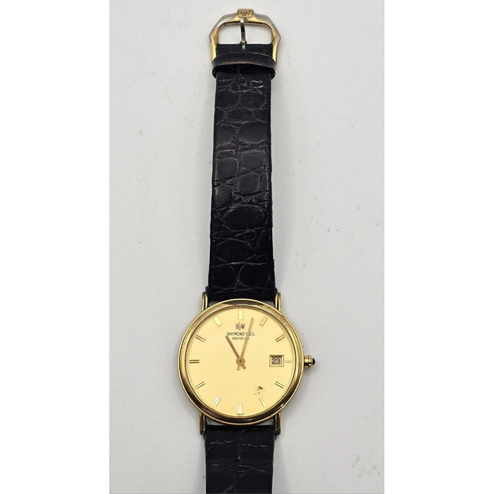 Gold wristwatch with black leather strap