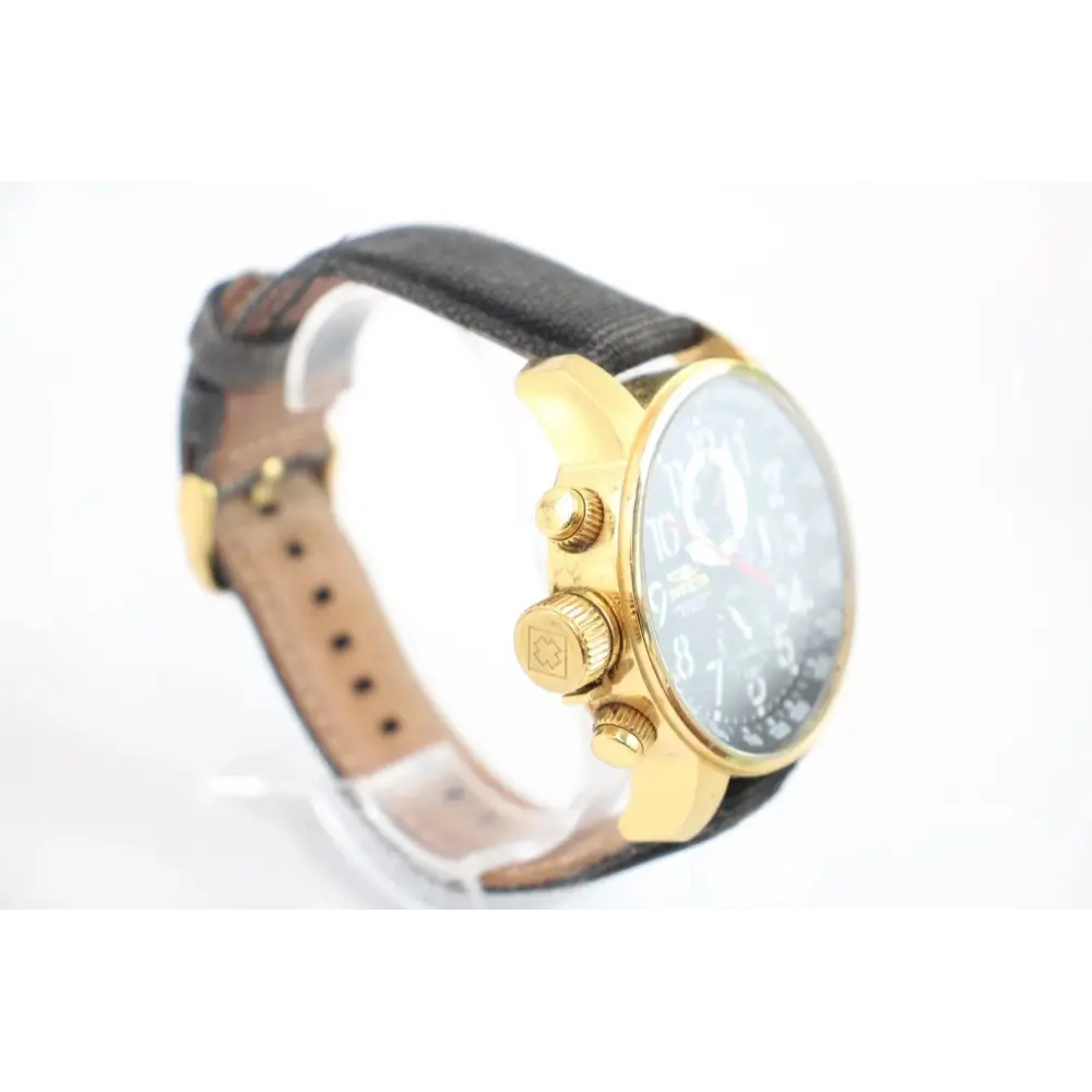 Watch with gold case and black leather strap