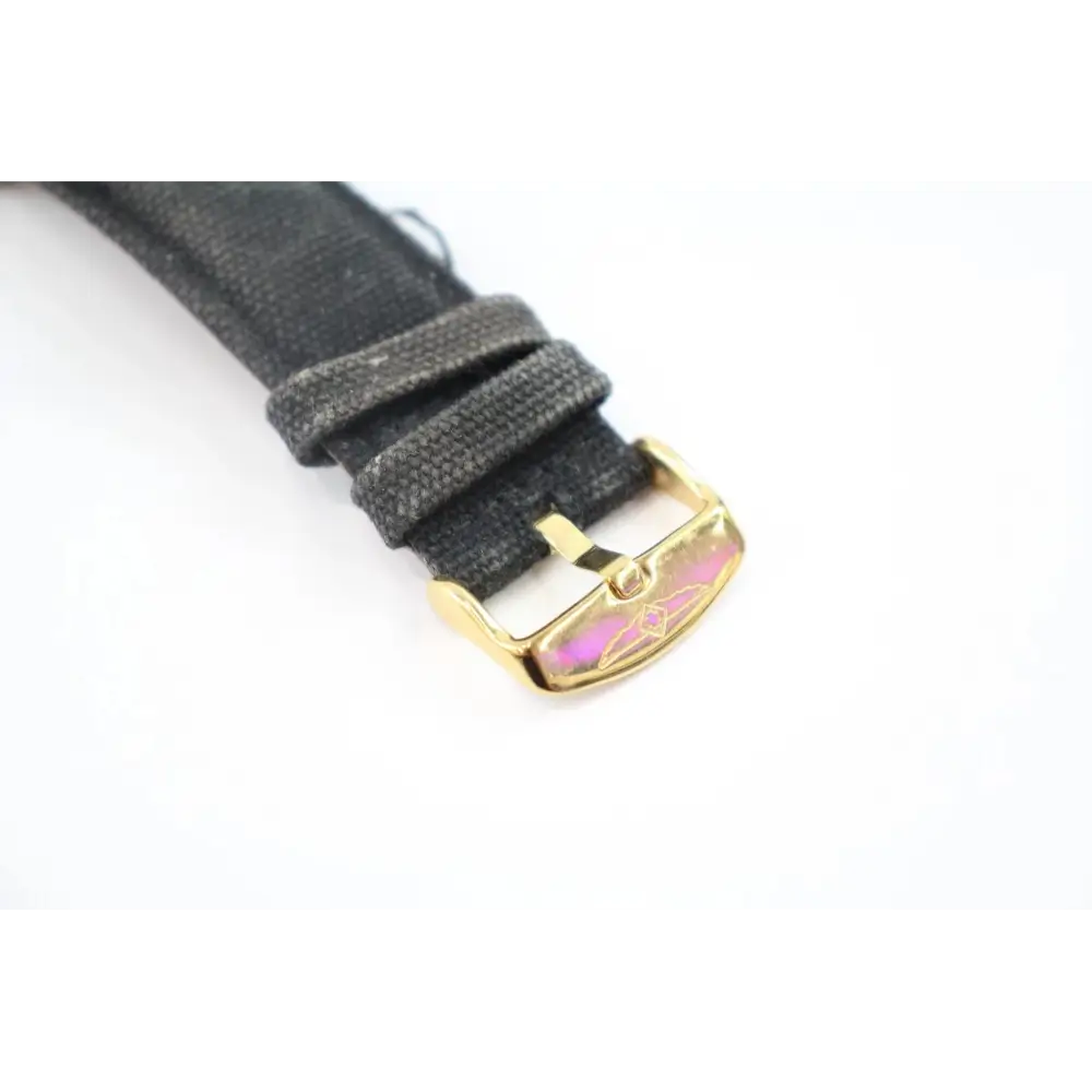 Gray watch strap with gold buckle on a white background