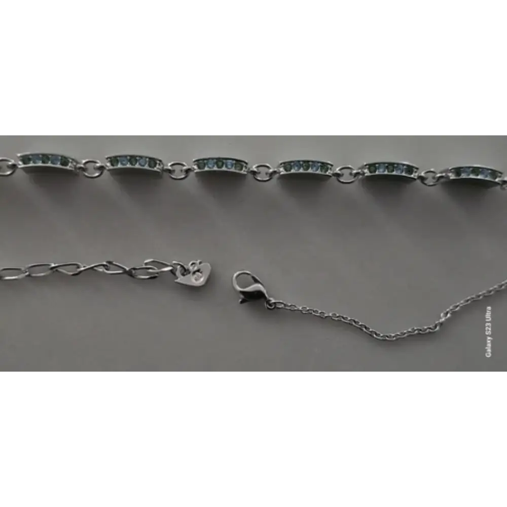 Silver bracelet with clasp on a gray background