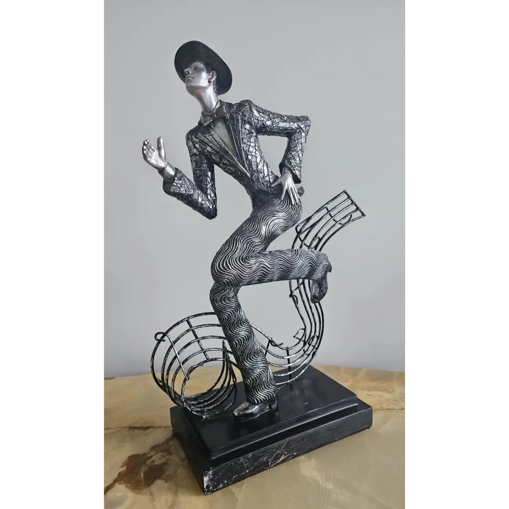 Decorative sculpture of a person in a suit with musical elements