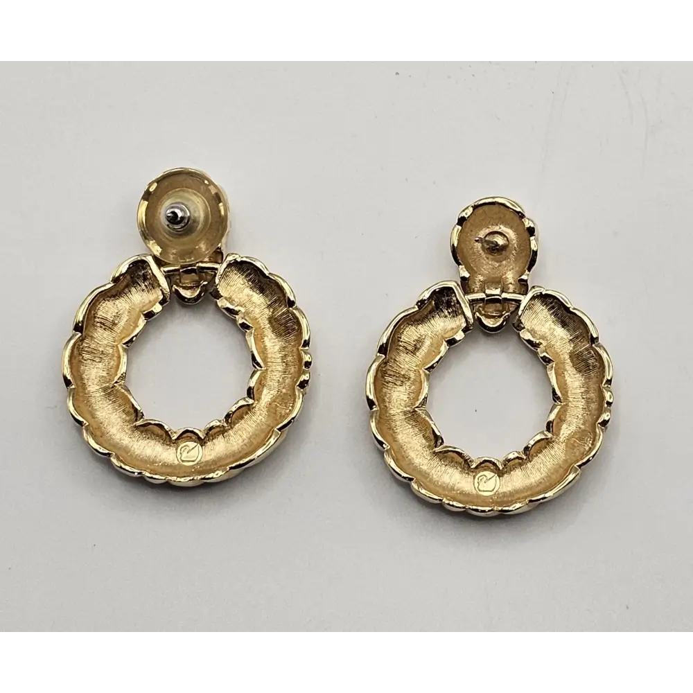 Pair of gold hoop earrings on a gray background