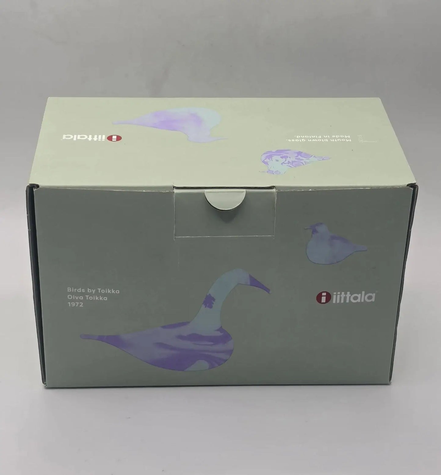 A square product box for the iiftala Birds of Turkey Oiva Tolkko 1972, featuring a muted sage green and lavender illustration of a goose and smaller bird silhouettes.