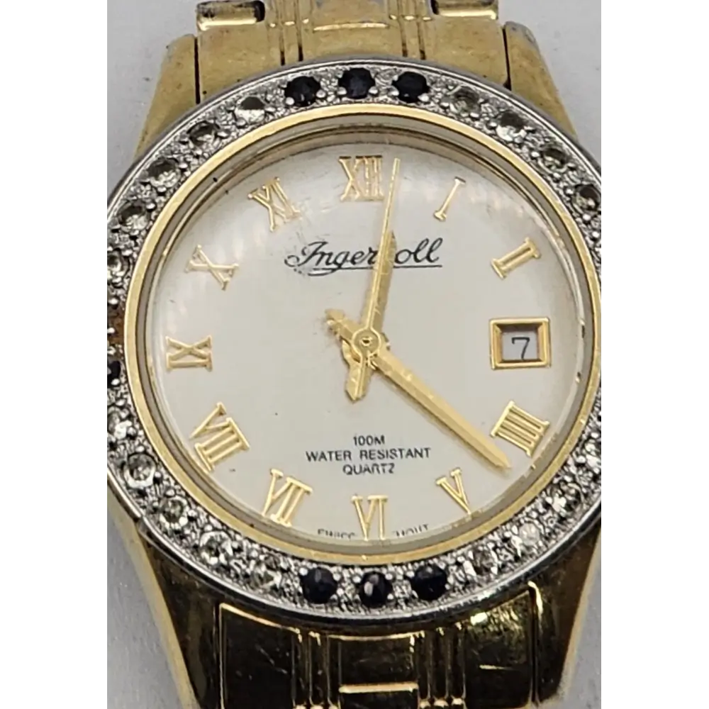 Gold wristwatch with diamond accents and Roman numeral markers