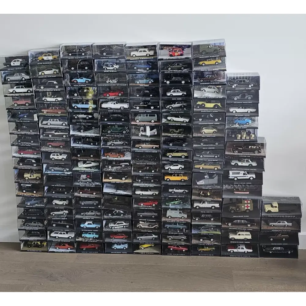 Stack of model car boxes on a plain background