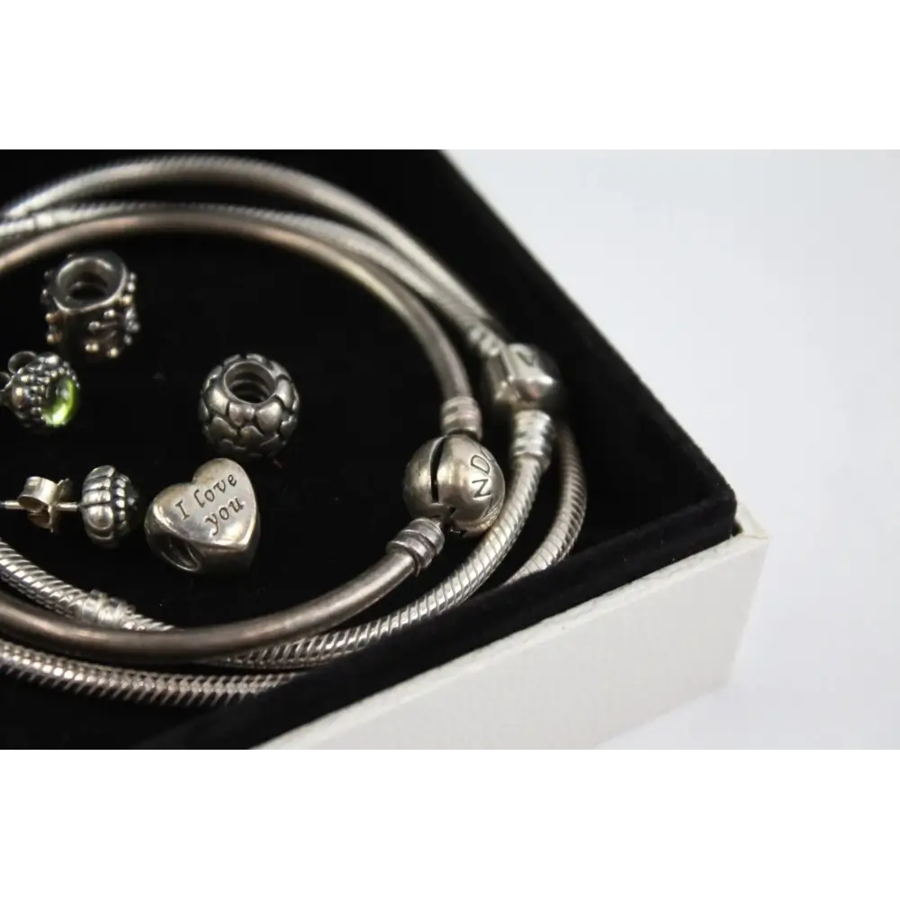 Silver bracelet with charms including 'I love you' heart charm