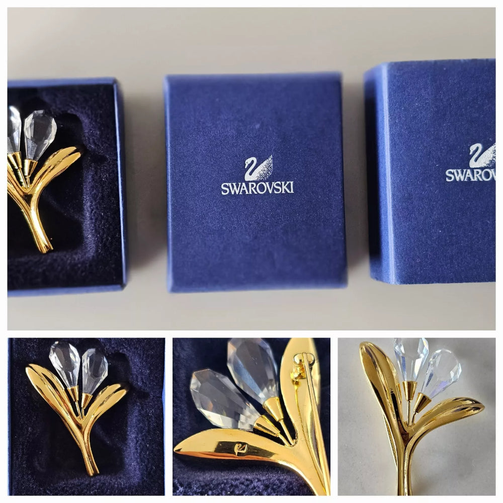 Gold and crystal brooch in a Swarovski box with close-up views.