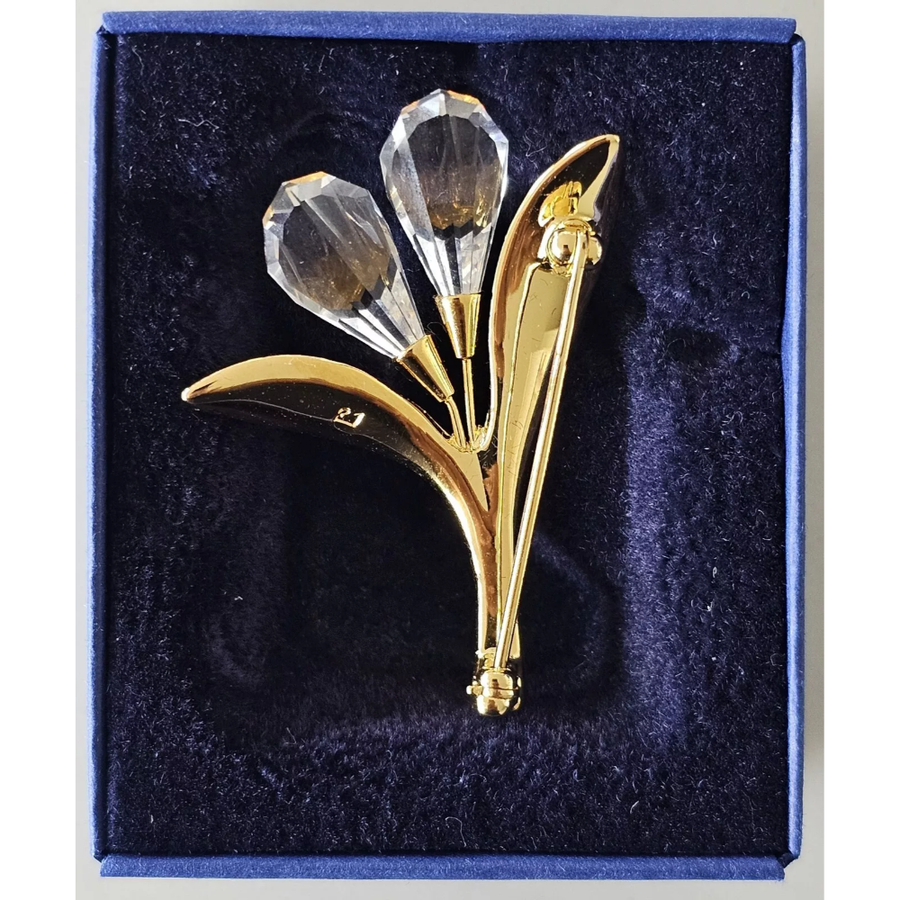 Gold and crystal brooch in a blue box