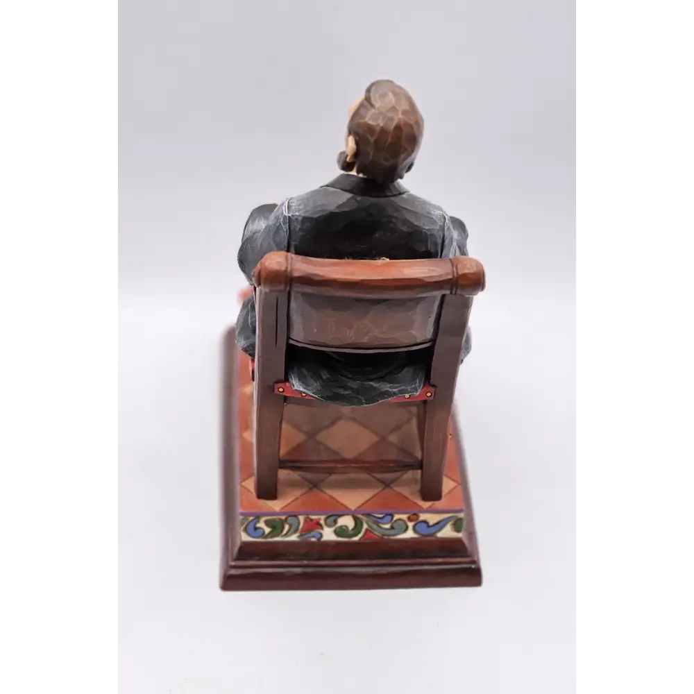 Statue of a person sitting on a chair