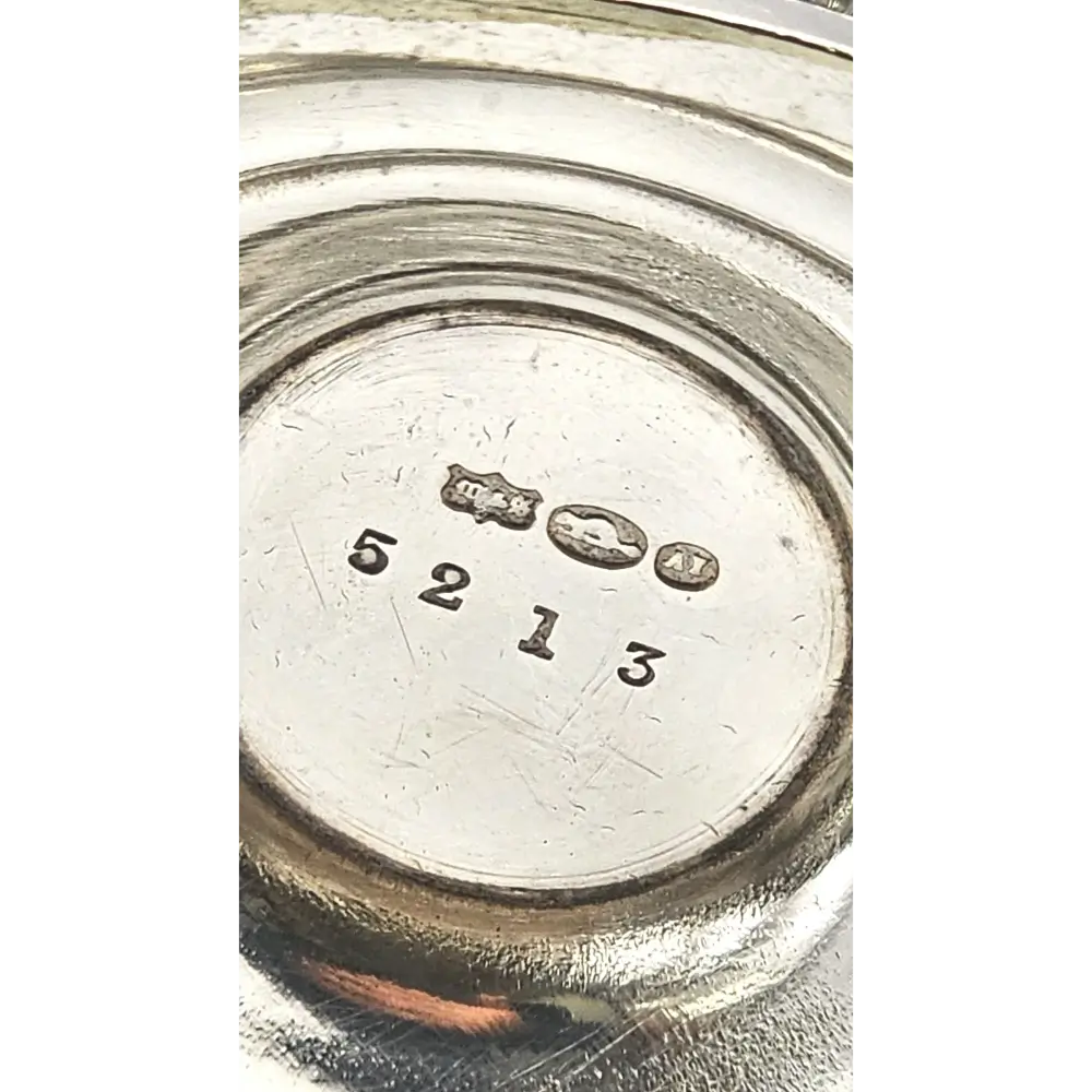 Close-up of a silver object with engraved numbers and symbols