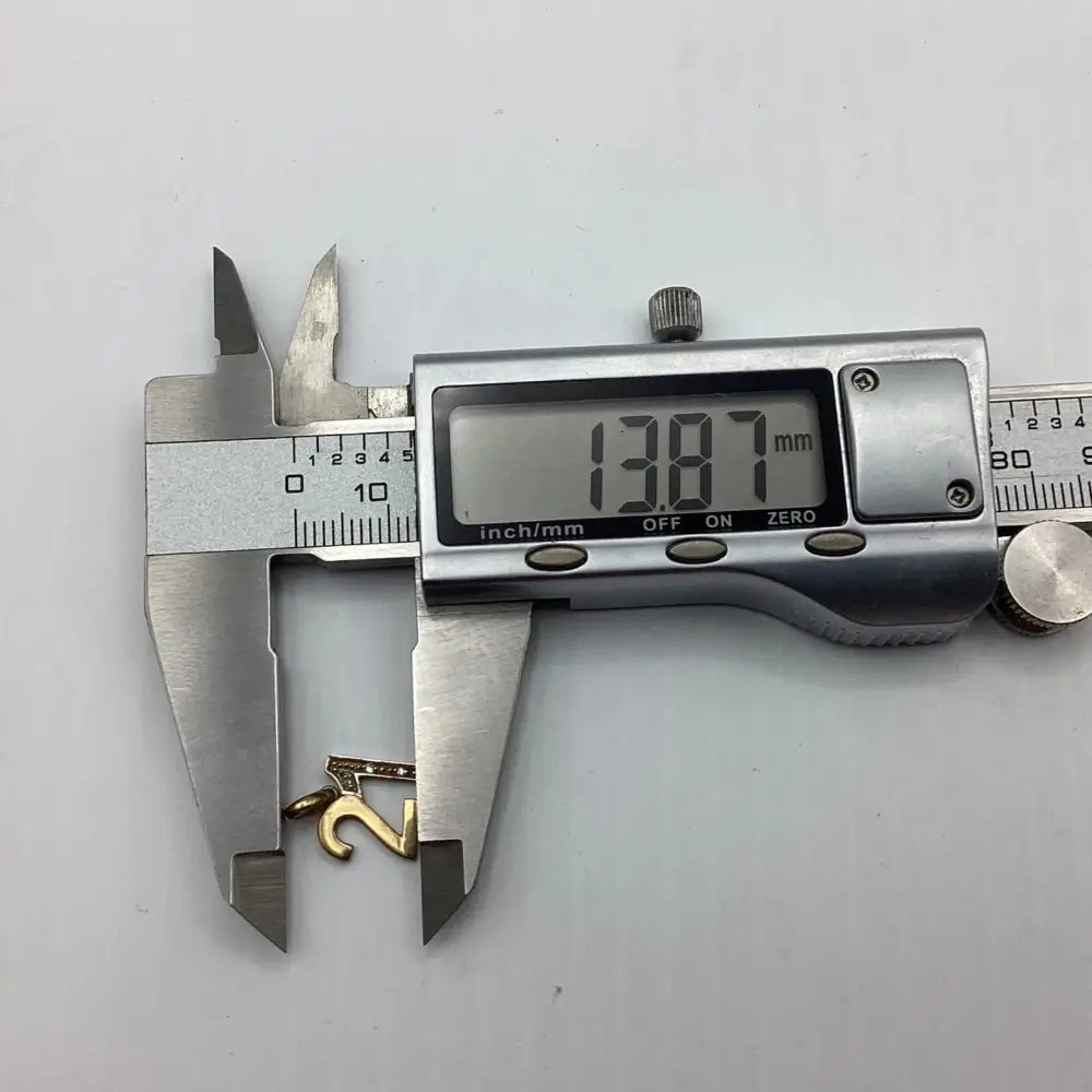 Digital caliper measuring a gold ring