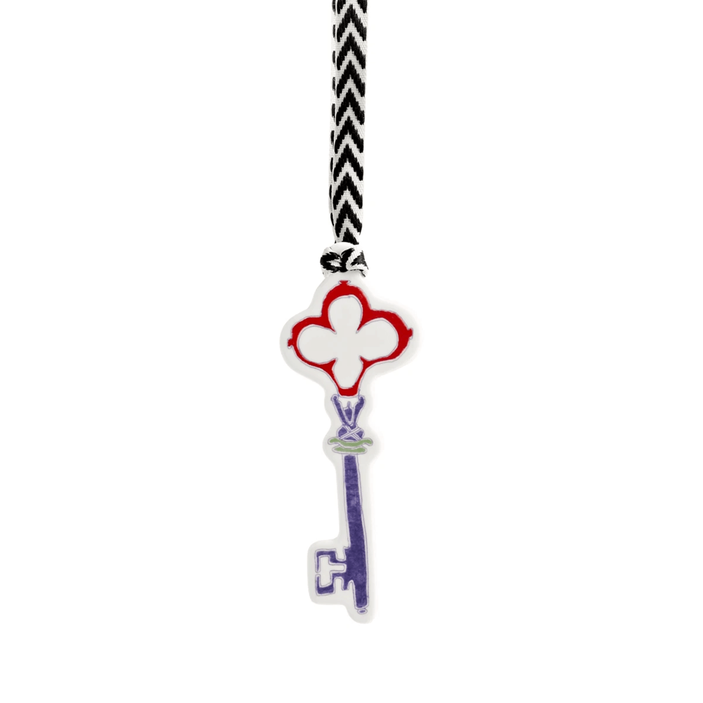 Key-shaped charm with clover design
