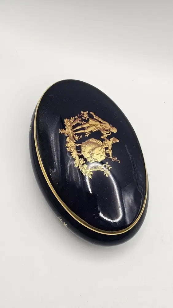 Blue oval compact with gold decorative design
