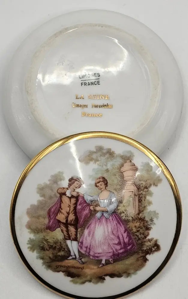Decorative plate with a couple in a garden scene, featuring the brand 'Gien France' on the back.