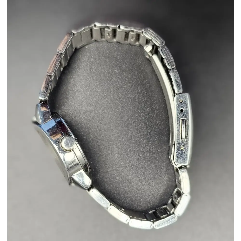 Metallic watch on a gray background