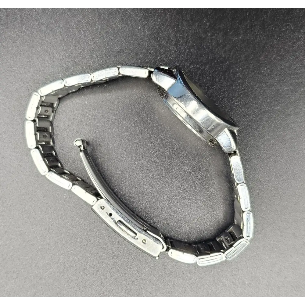 Metallic watch on a gray background