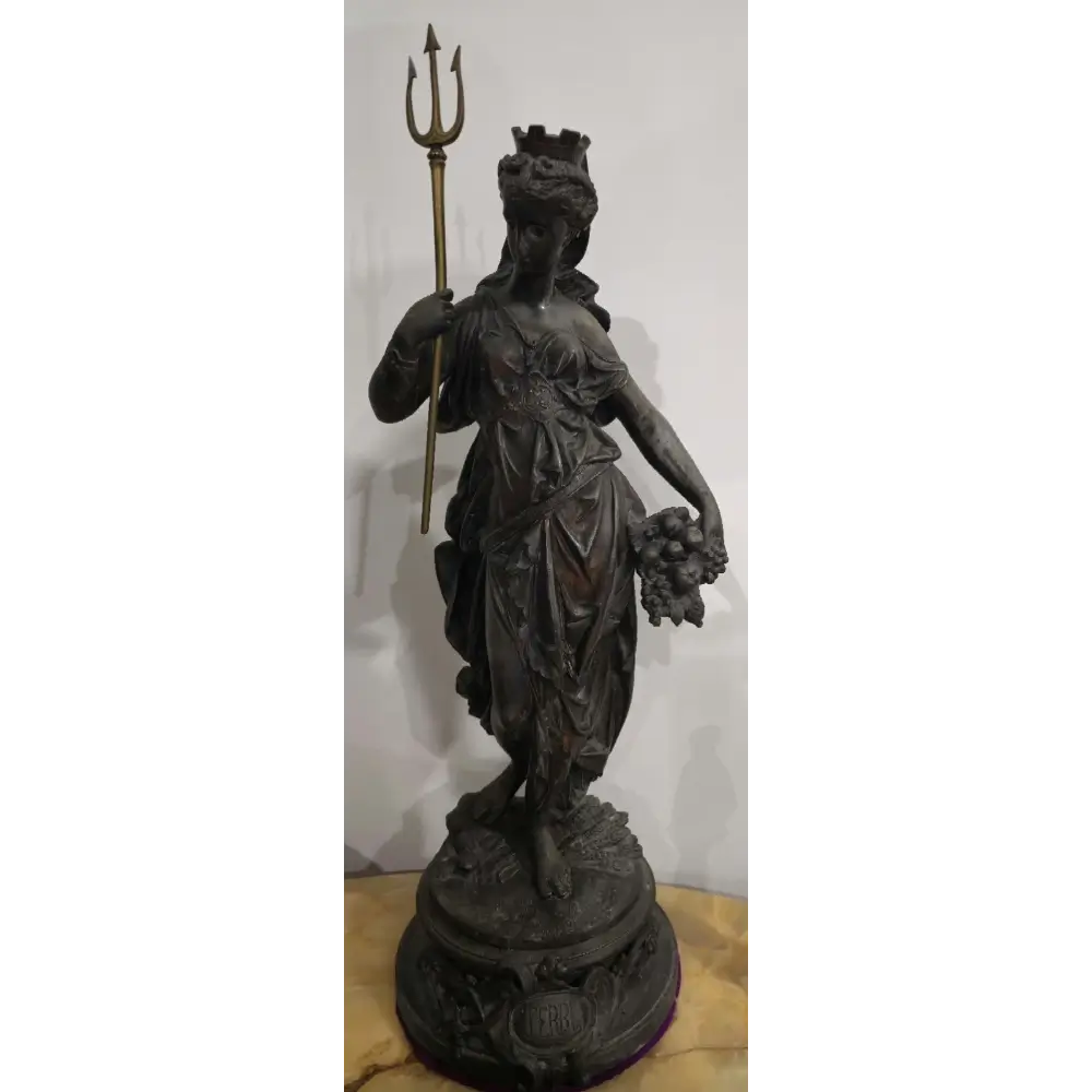 Statue of a figure holding a trident and fruit on a white background