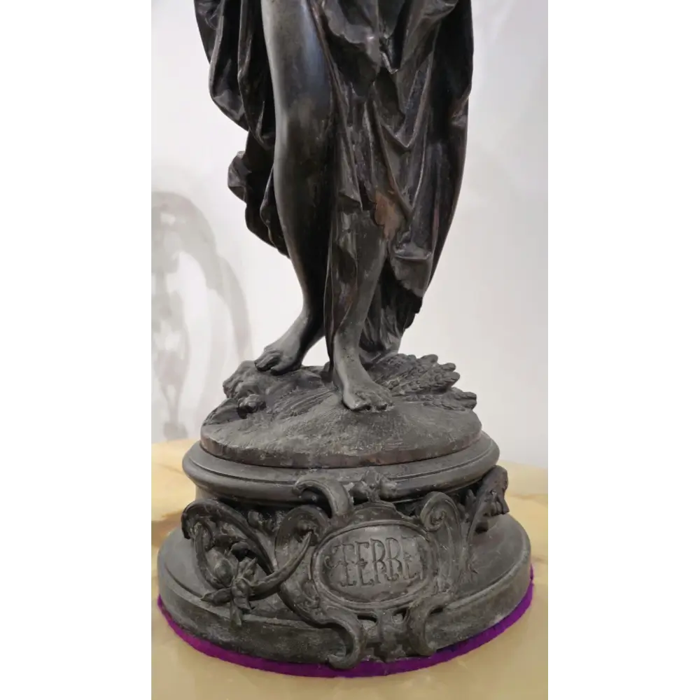 Bronze statue on a pedestal with 'HERB' engraved