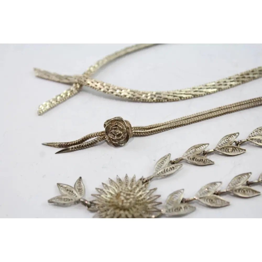 Gold necklaces with floral and leaf designs