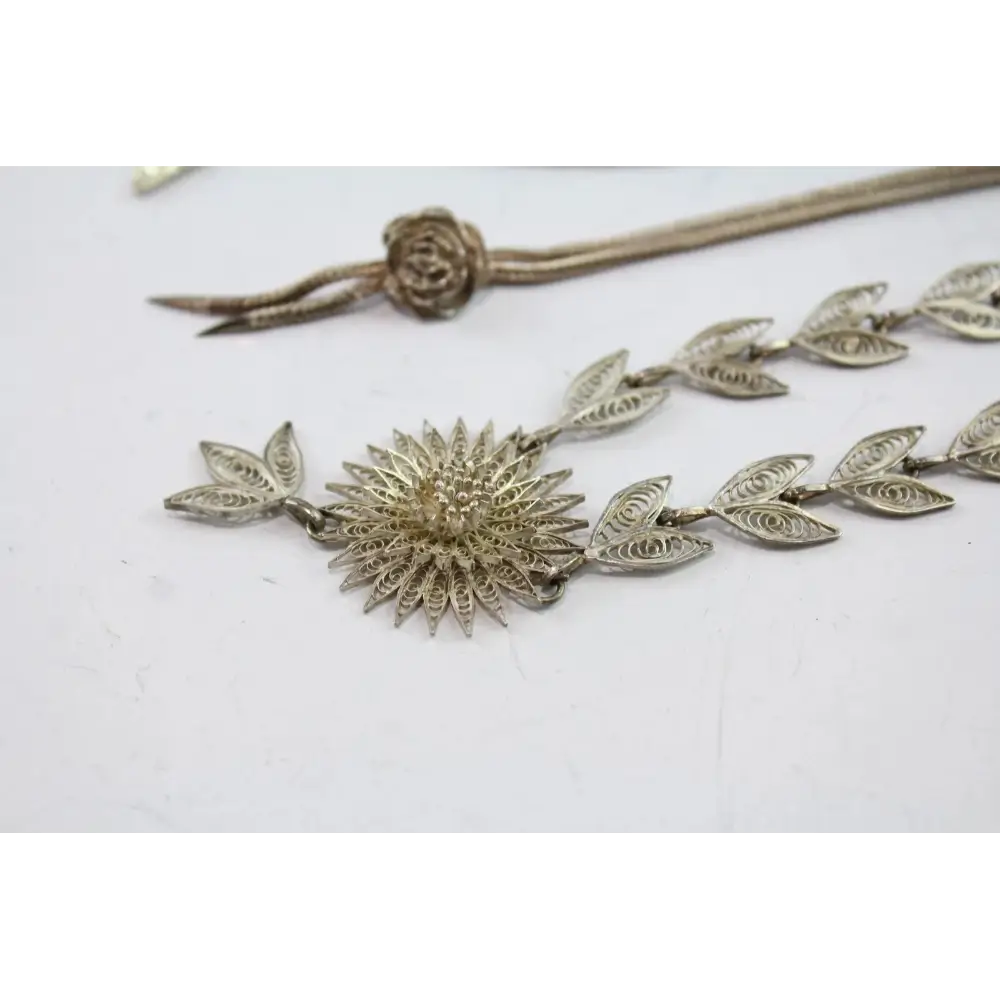 Silver floral necklace on a white background