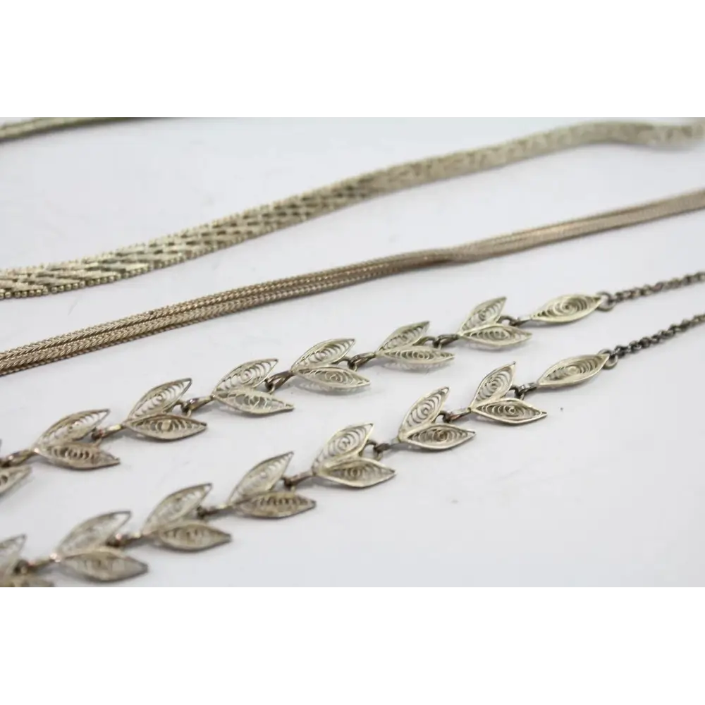 Silver leaf-patterned necklace on a white background