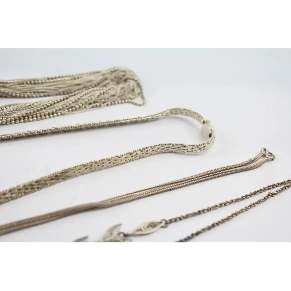 Collection of gold necklaces on a light gray background