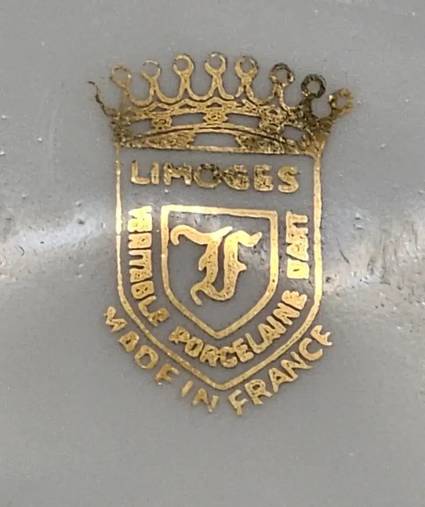 Gold emblem with 'Limoges' and 'F' on a gray background