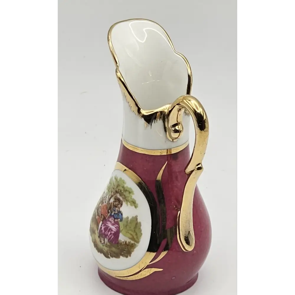 Decorative ceramic pitcher with gold accents