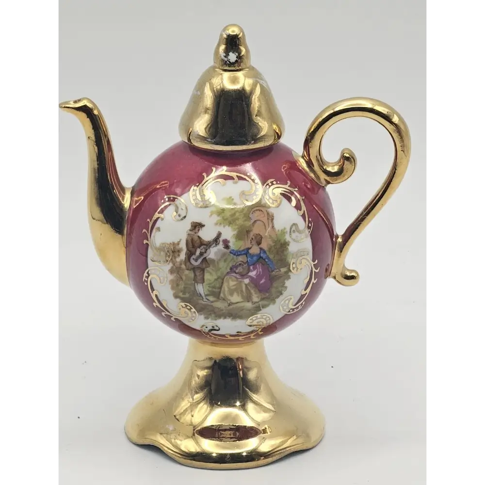 Decorative teapot with gold accents and a detailed design