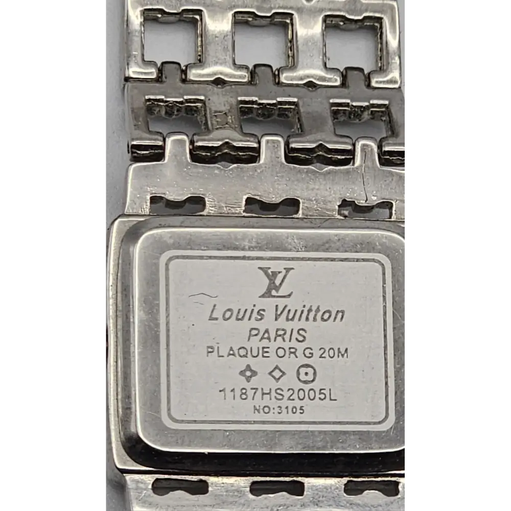 Louis Vuitton metal plaque with brand logo and text