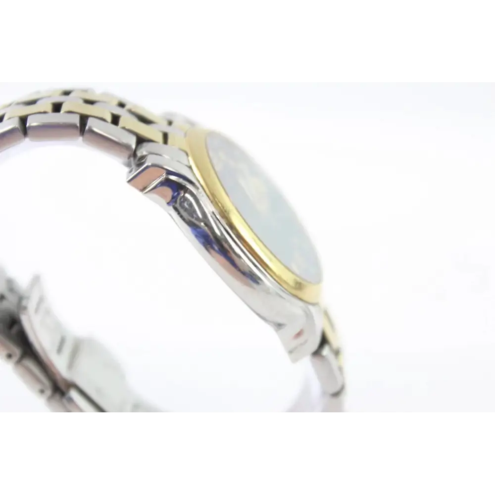 Close-up of a silver and gold watch band