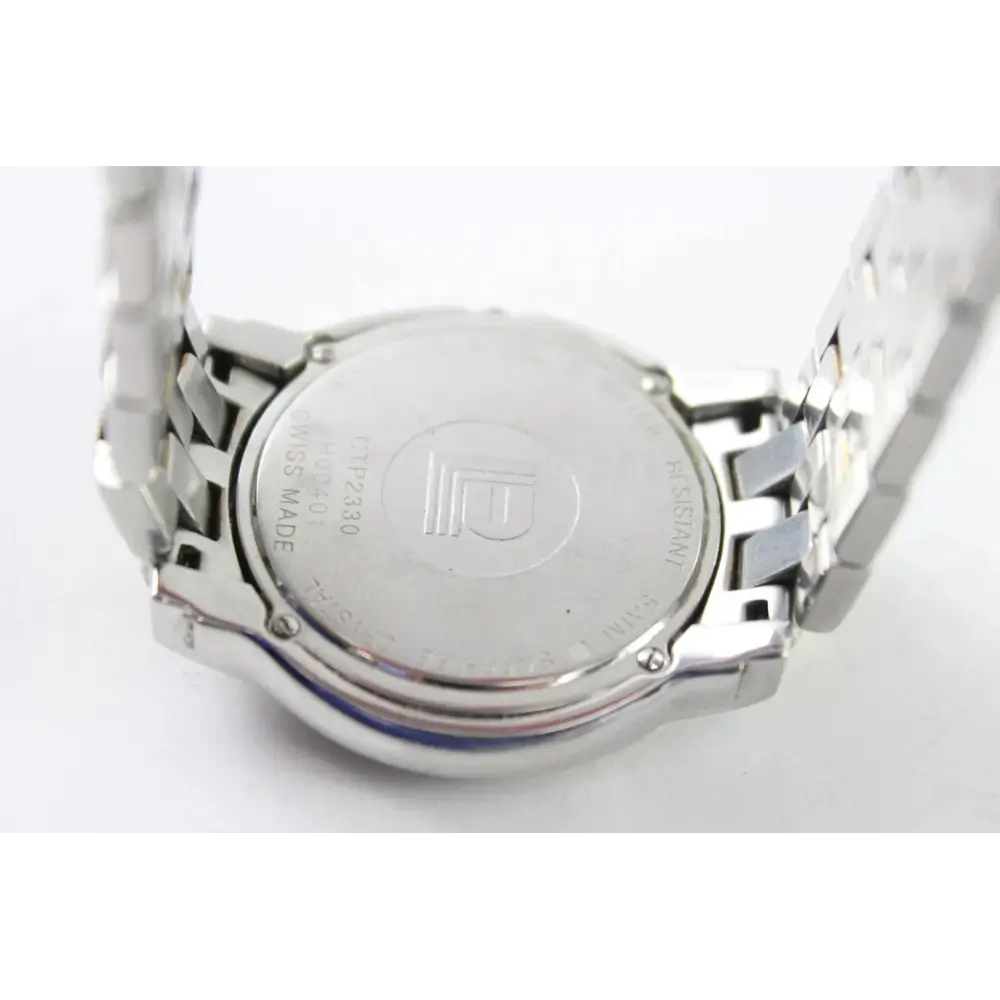 Close-up of a silver watch with brand logo