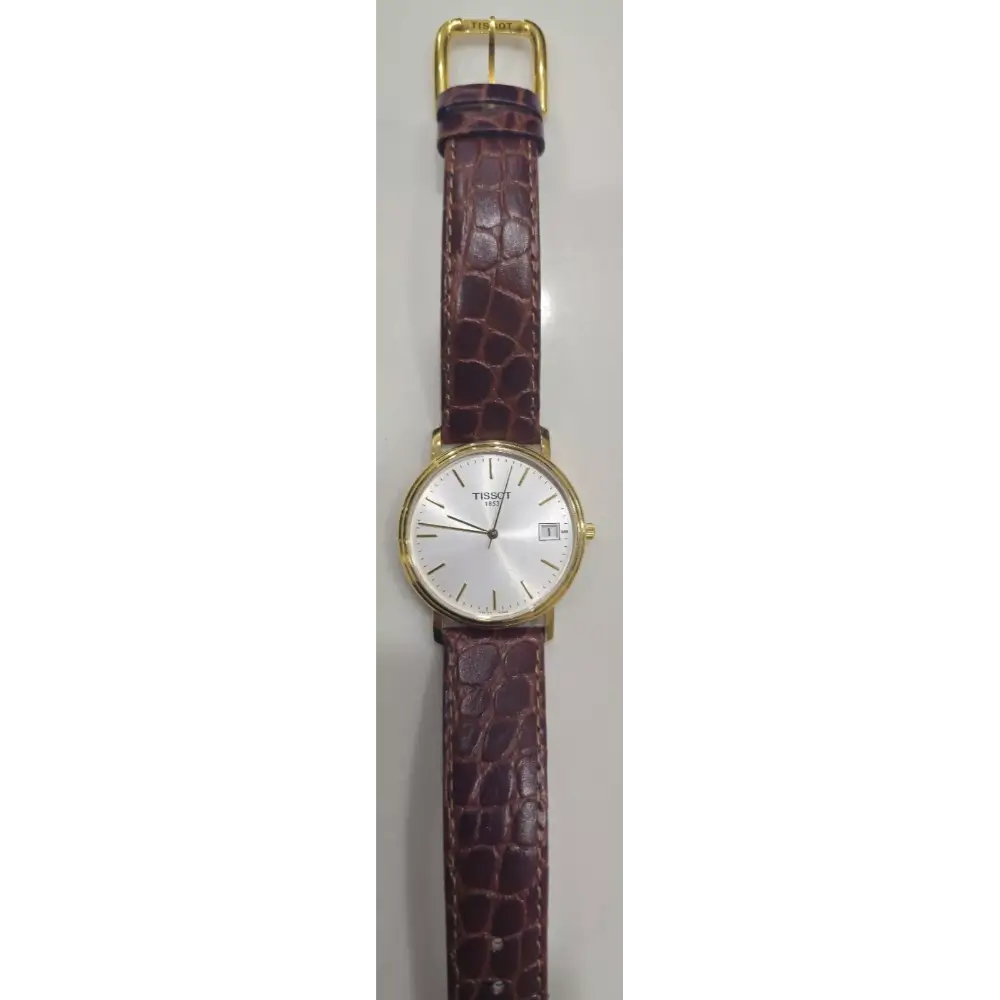 Watch with a brown strap and gold case on a white background