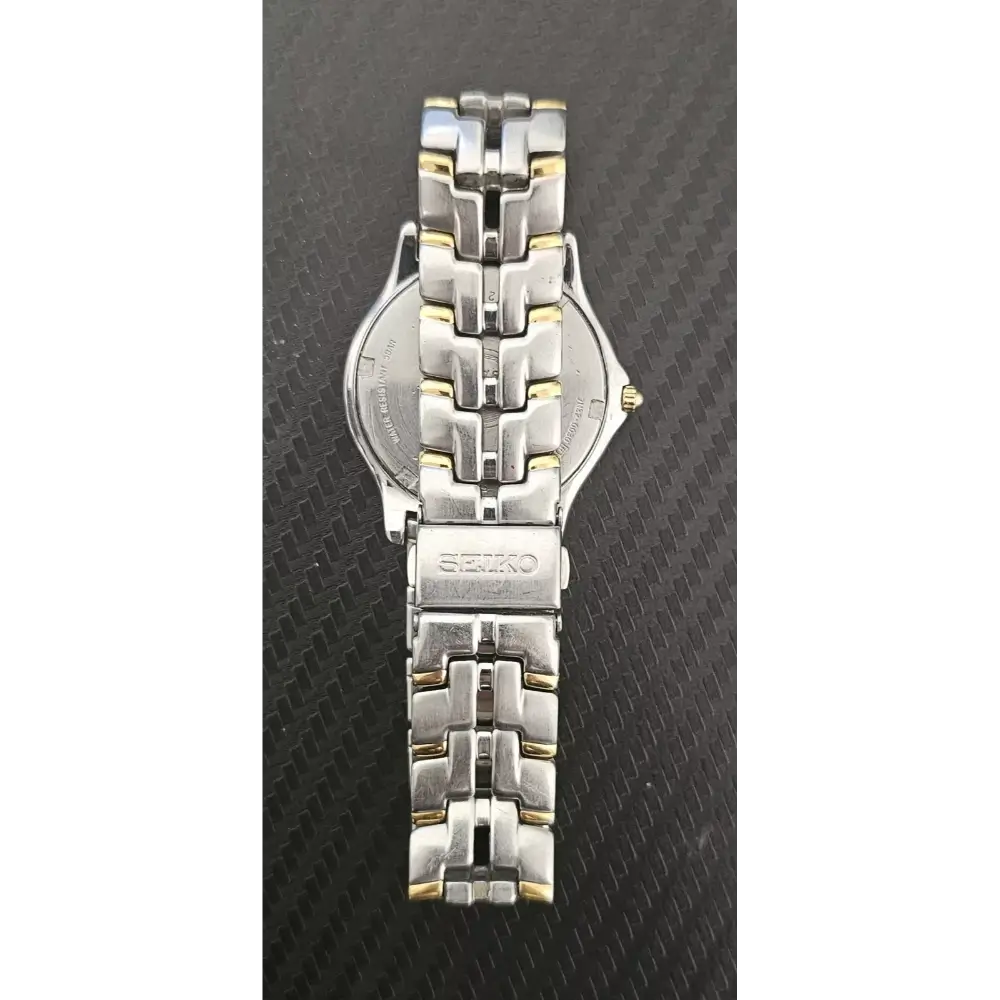Silver Seiko watch on a textured black