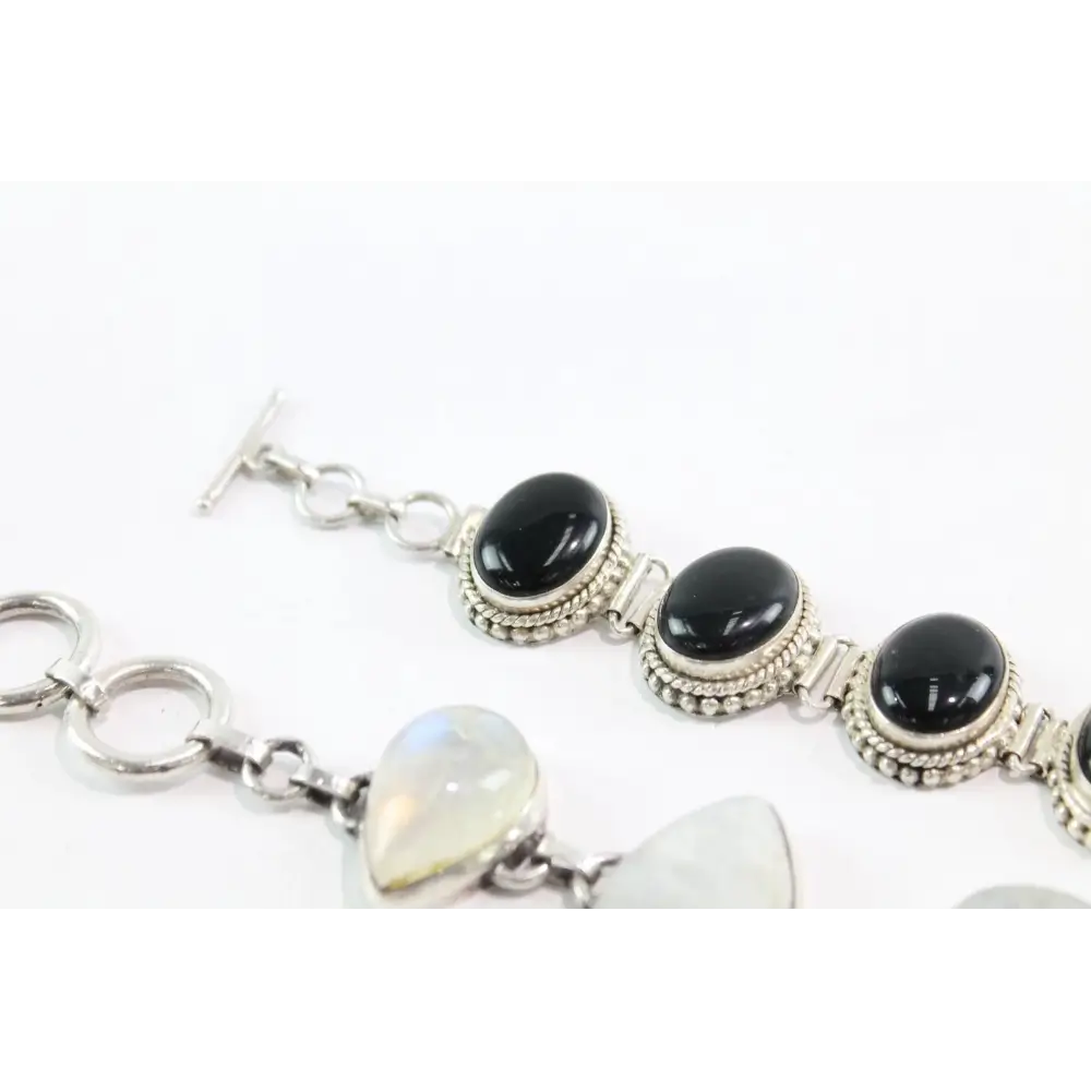 Bracelet with black beads and silver accents on a white background
