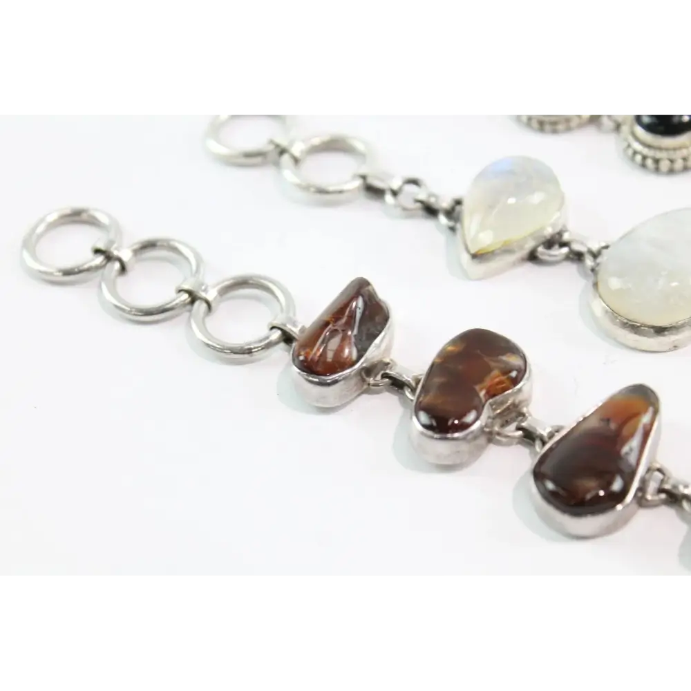 Silver bracelet with heart-shaped gemstones on a white background
