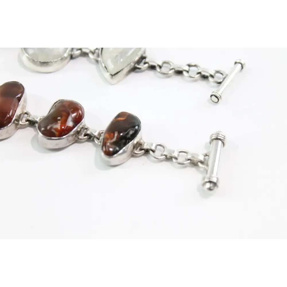 Silver bracelet with amber beads on a white background