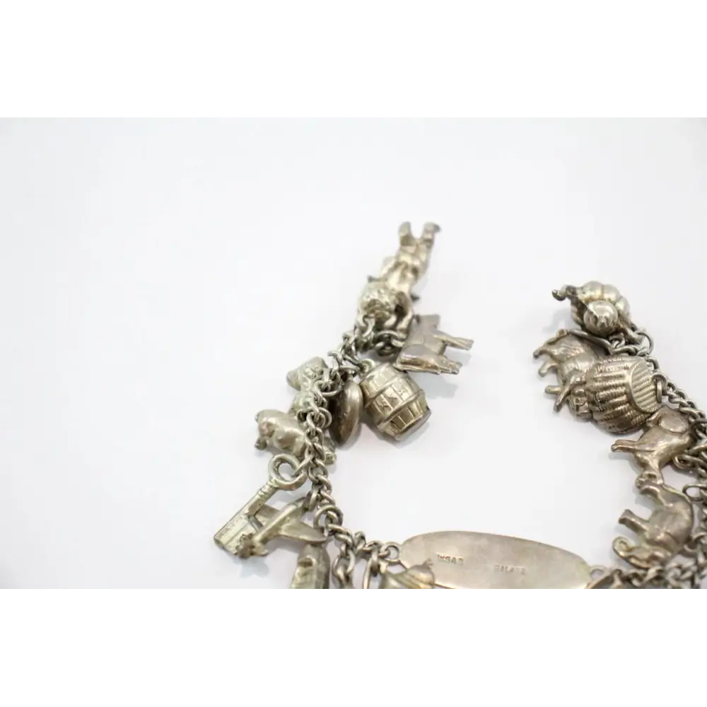 Silver charm bracelet with various charms