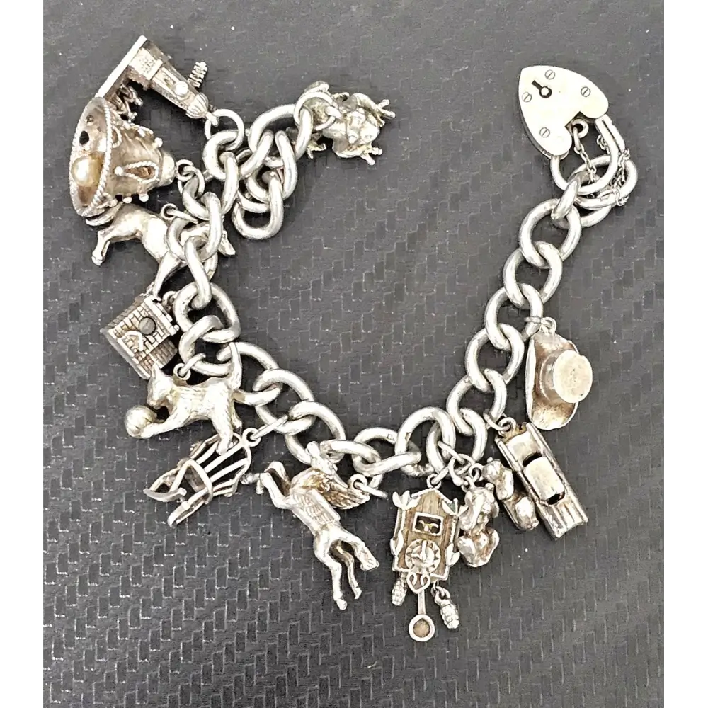 Silver charm bracelet with various charms