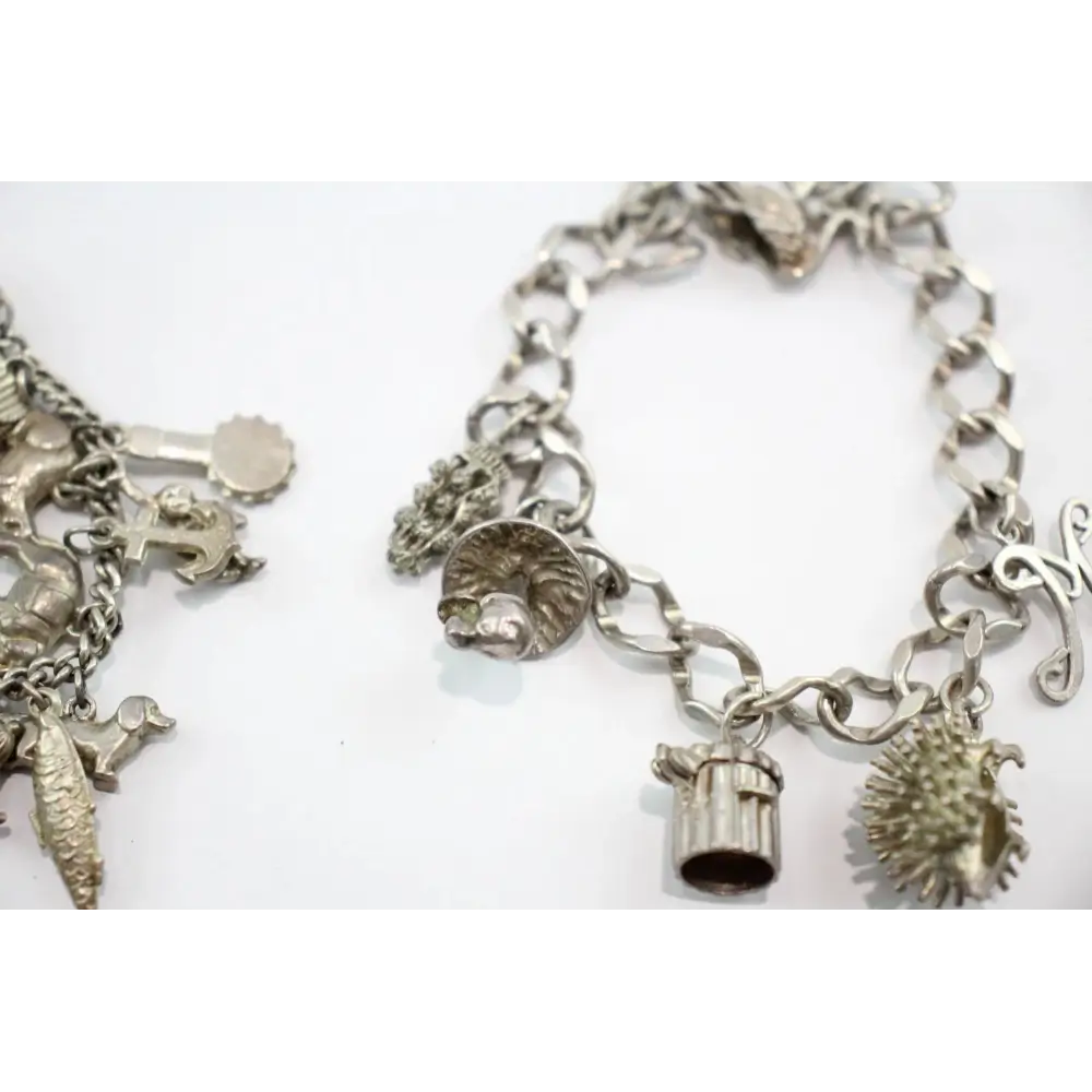 Silver charm bracelets on a white background