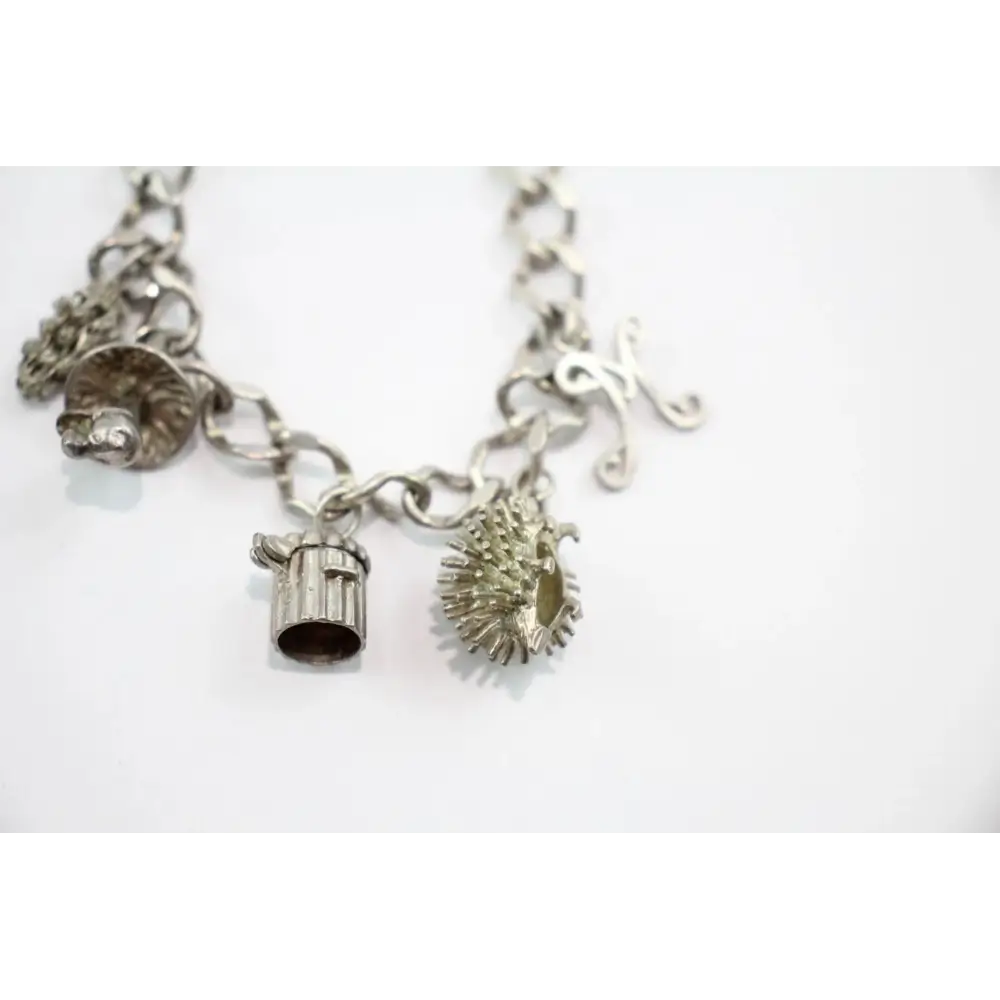 Silver charm bracelet with various charms