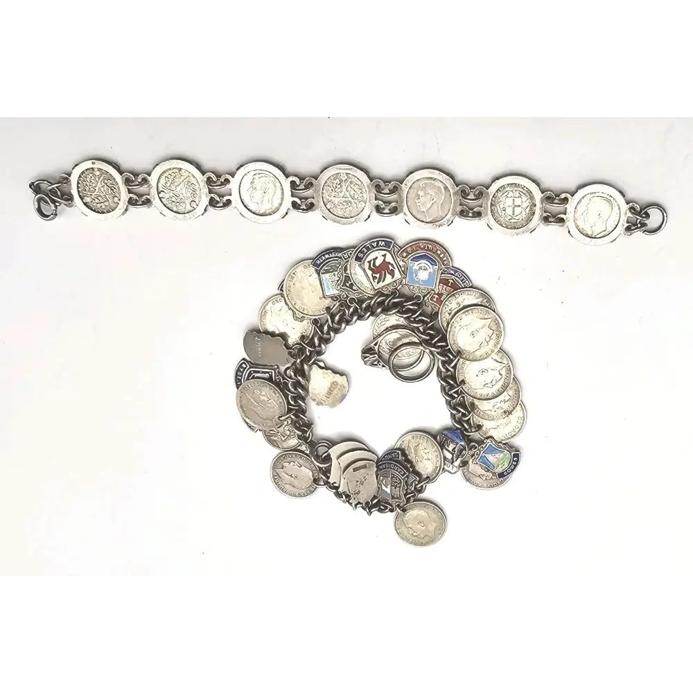 Silver bracelet with various charms on a white background
