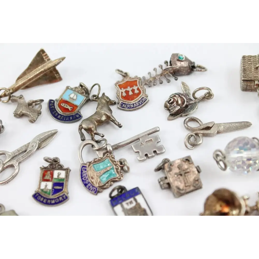 Collection of various silver charms on a white background