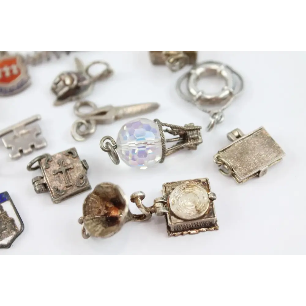 Collection of various silver charms on a white background
