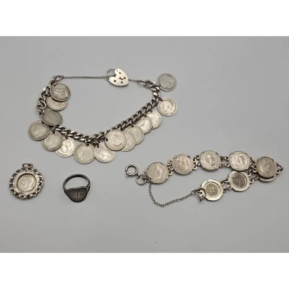 Silver jewelry set with coins on a gray background