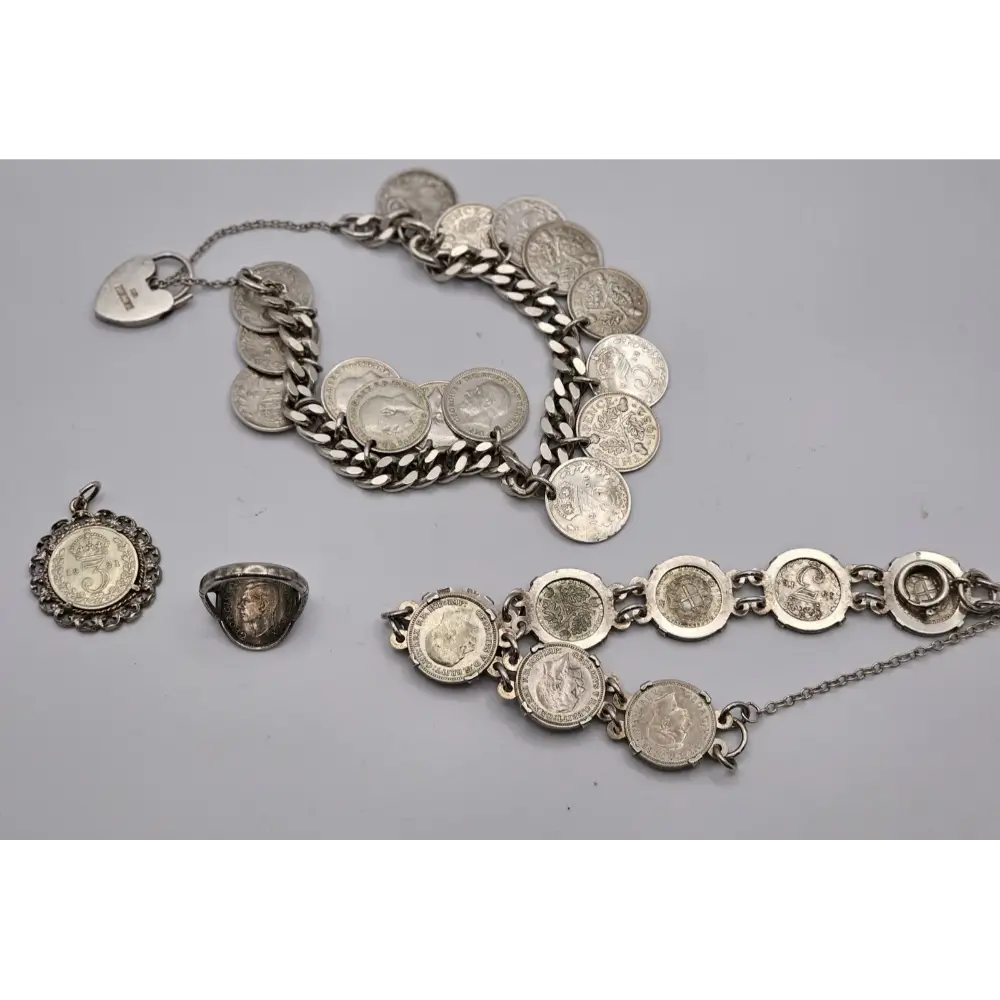 Silver jewelry set including a bracelet, necklace, and ring on a gray background