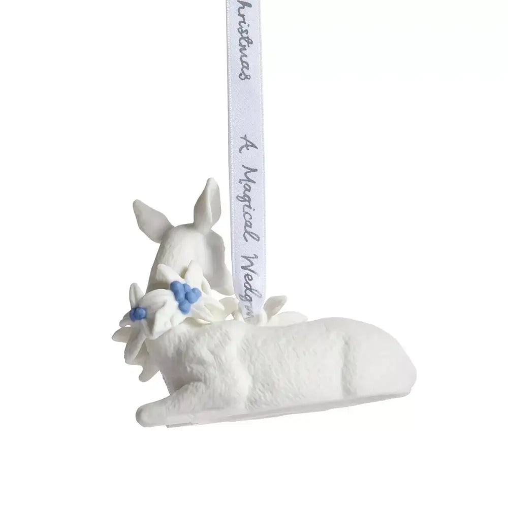 White deer figurine with a ribbon