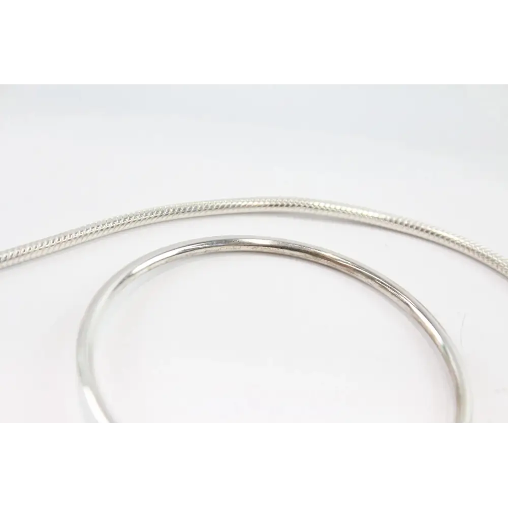 Silver bracelet on a light gray background